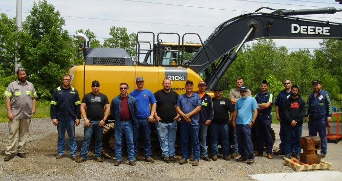 June 2018 NPK Service Conference - group shot with the excavator used for the rodeo